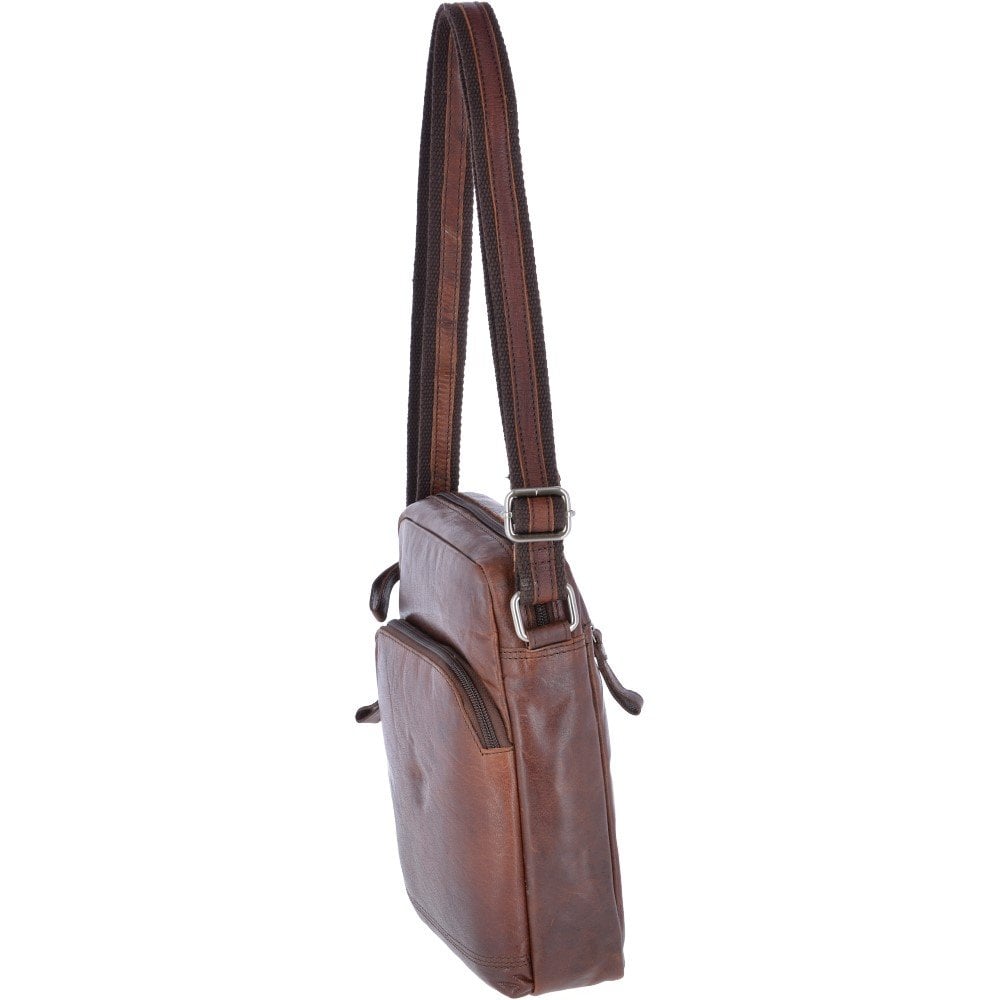 "Compact men’s shoulder bag by Ashwood in rich brandy-colored genuine leather, model F82, ideal for daily use. Features include a padded compartment for a 12-inch tablet, multiple internal organizers, and a vintage-style 'Oily Buff Crumble' leather finish. Designed with an adjustable shoulder strap and secure zipper closures, this bag combines classic aesthetics with modern utility, making it suitable for both casual and professional settings."