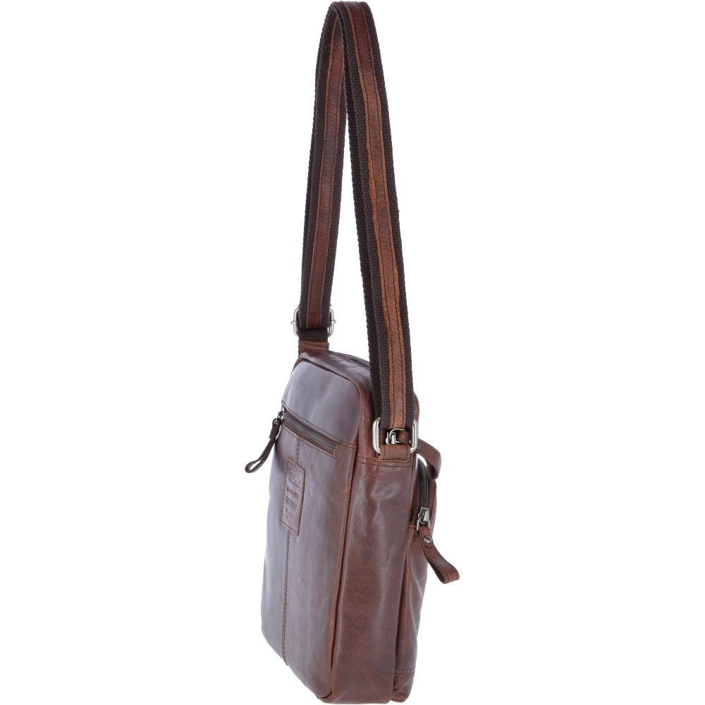 "Compact men’s shoulder bag by Ashwood in rich brandy-colored genuine leather, model F82, ideal for daily use. Features include a padded compartment for a 12-inch tablet, multiple internal organizers, and a vintage-style 'Oily Buff Crumble' leather finish. Designed with an adjustable shoulder strap and secure zipper closures, this bag combines classic aesthetics with modern utility, making it suitable for both casual and professional settings."