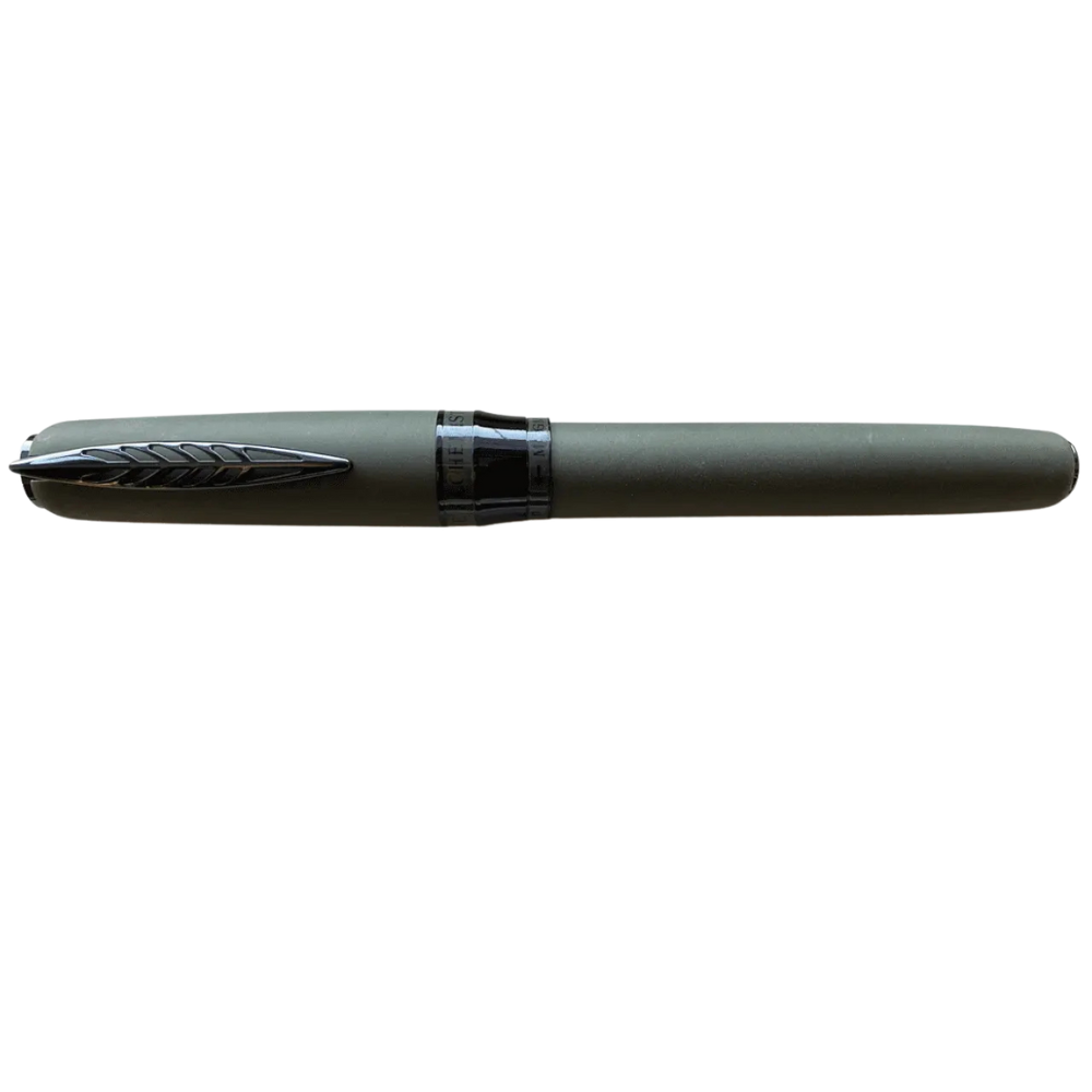 "Pineider Alchemist fountain pen in Krakatoa Green, crafted from a unique blend of zeolite and resin with a black-green finish and black trim. Features Pineider’s soft-touch magnetic lock cap, a black-plated stainless steel nib (size No.6), and includes an ink converter compatible with standard cartridges. Presented in a gift box, this luxury pen combines elegant design with volcanic-inspired materials, perfect for collectors and writing enthusiasts."