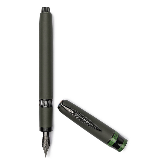 "Pineider Alchemist fountain pen in Krakatoa Green, crafted from a unique blend of zeolite and resin with a black-green finish and black trim. Features Pineider’s soft-touch magnetic lock cap, a black-plated stainless steel nib (size No.6), and includes an ink converter compatible with standard cartridges. Presented in a gift box, this luxury pen combines elegant design with volcanic-inspired materials, perfect for collectors and writing enthusiasts."